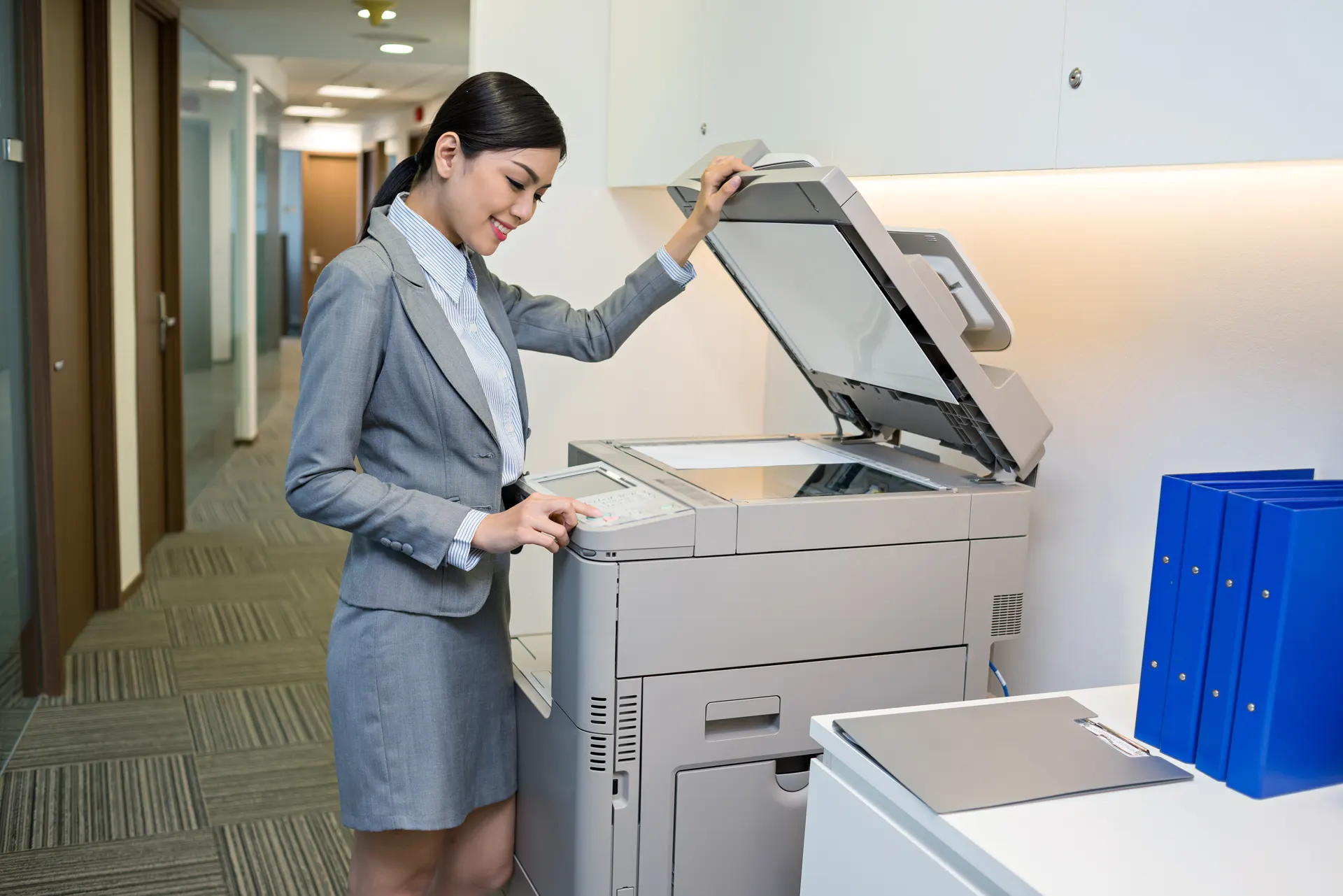 Office worker using a multifunction copier